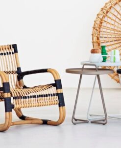 Unusual lounge chair, and a sure eye catcher, shaped from sustainable natural rattan with black bindings – lightweight yet strong and with a unique sculptural look.